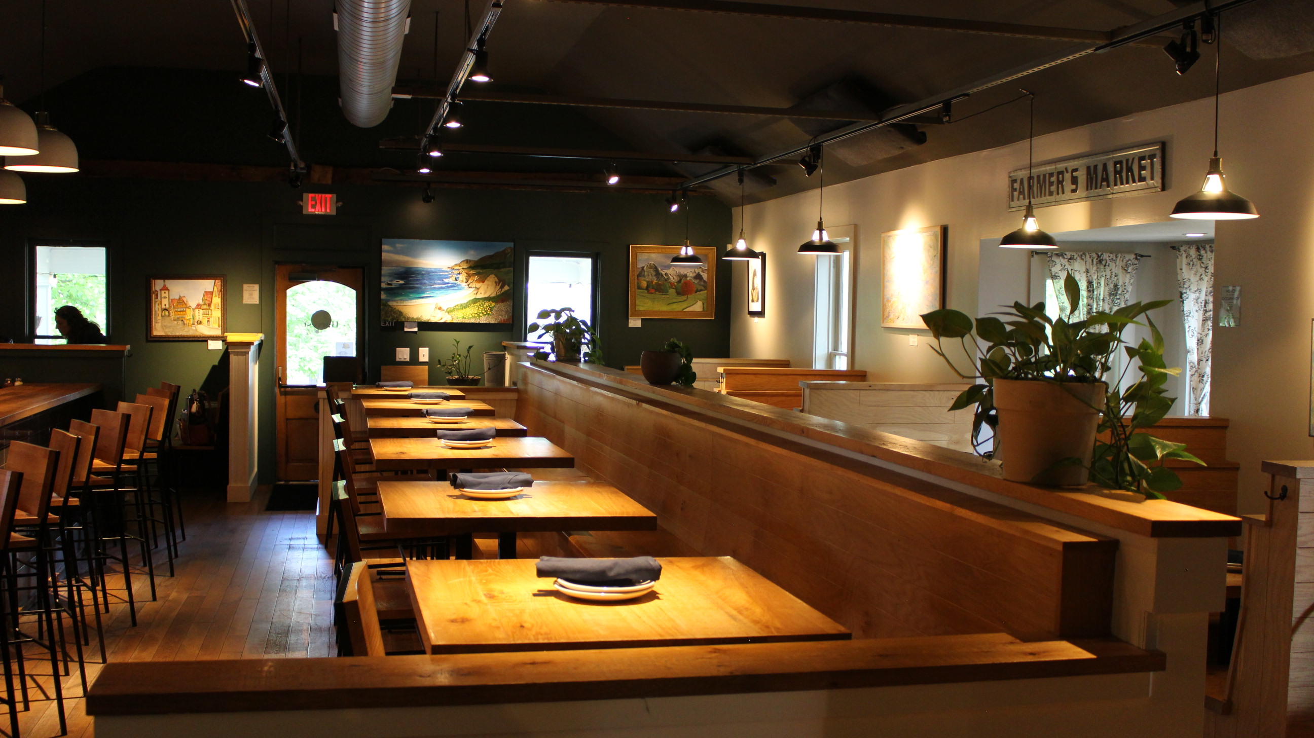 Communal bar-top seating in a Harvest dining room beneath a Farmer\'s Market sign