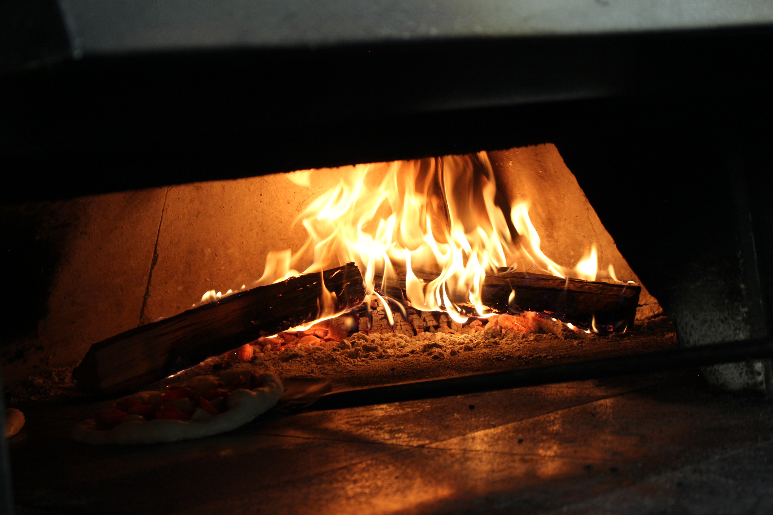 Live flame inside a Harvest wood-fired pizza oven