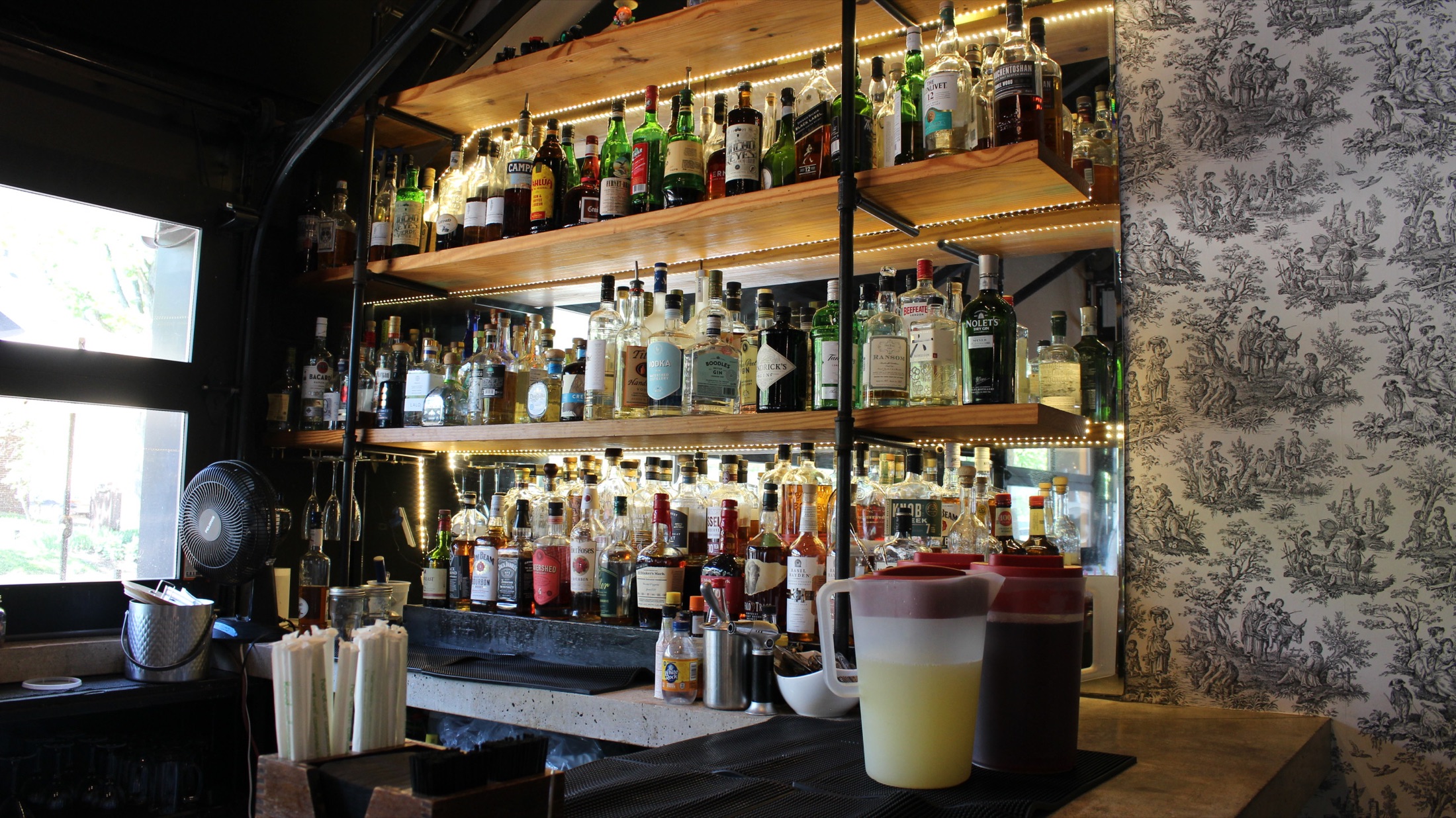 Bexley bar back with backlit spirits and toile wallpaper