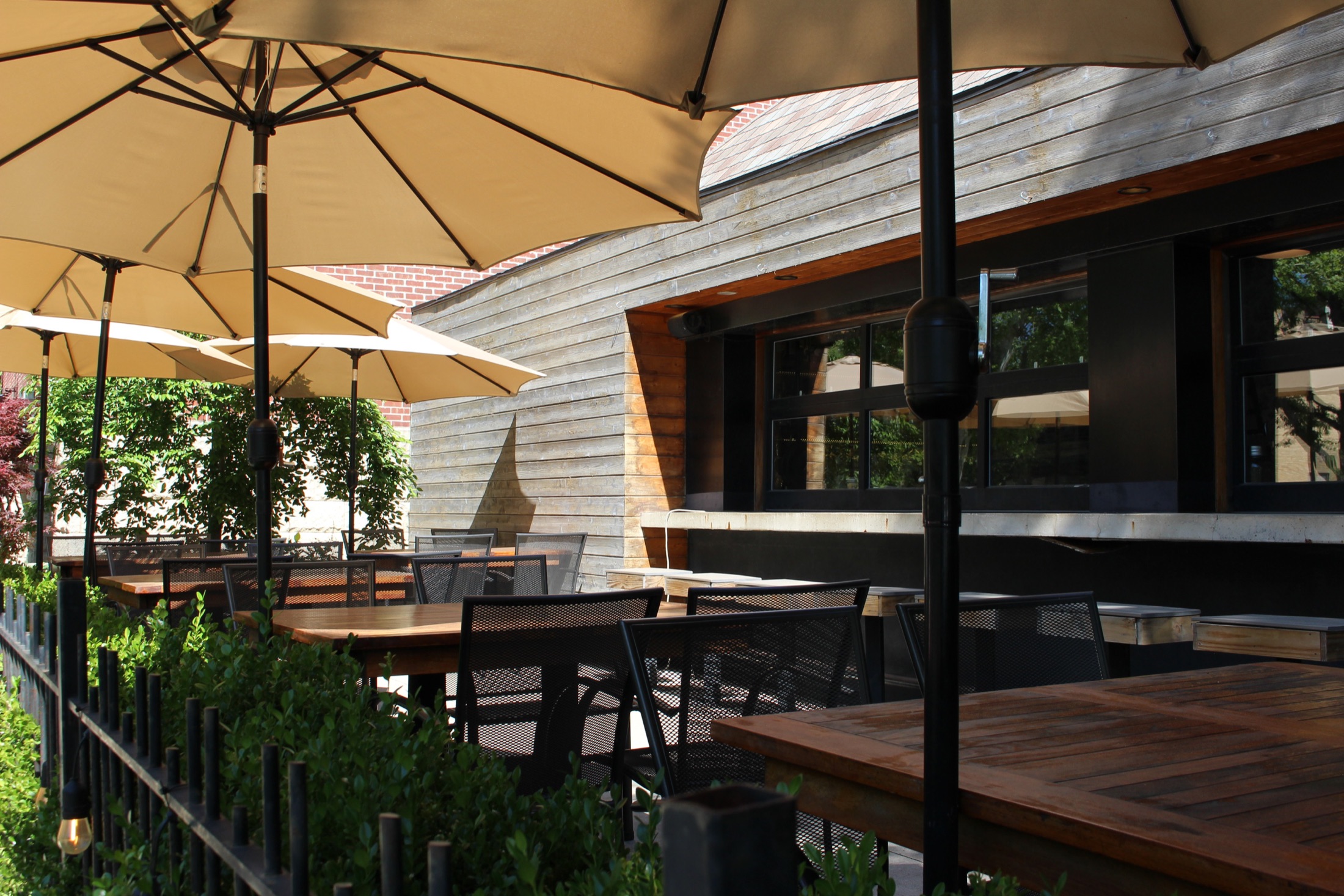 Bexley patio with cream umbrellas and metal mesh chairs