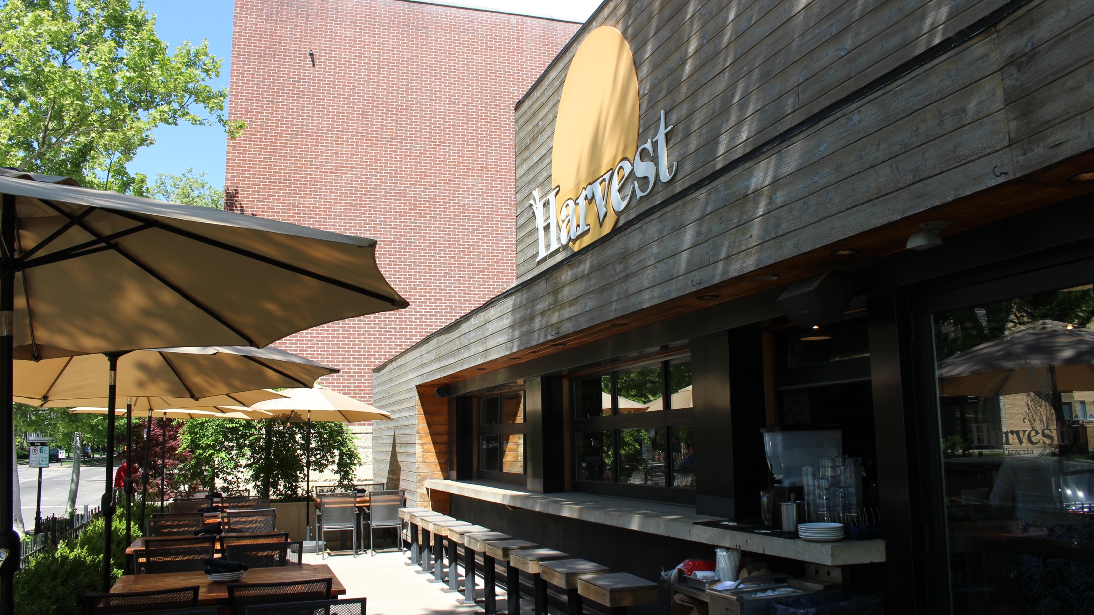 Harvest Bexley storefront with Harvest wordmark and outdoor patio bar