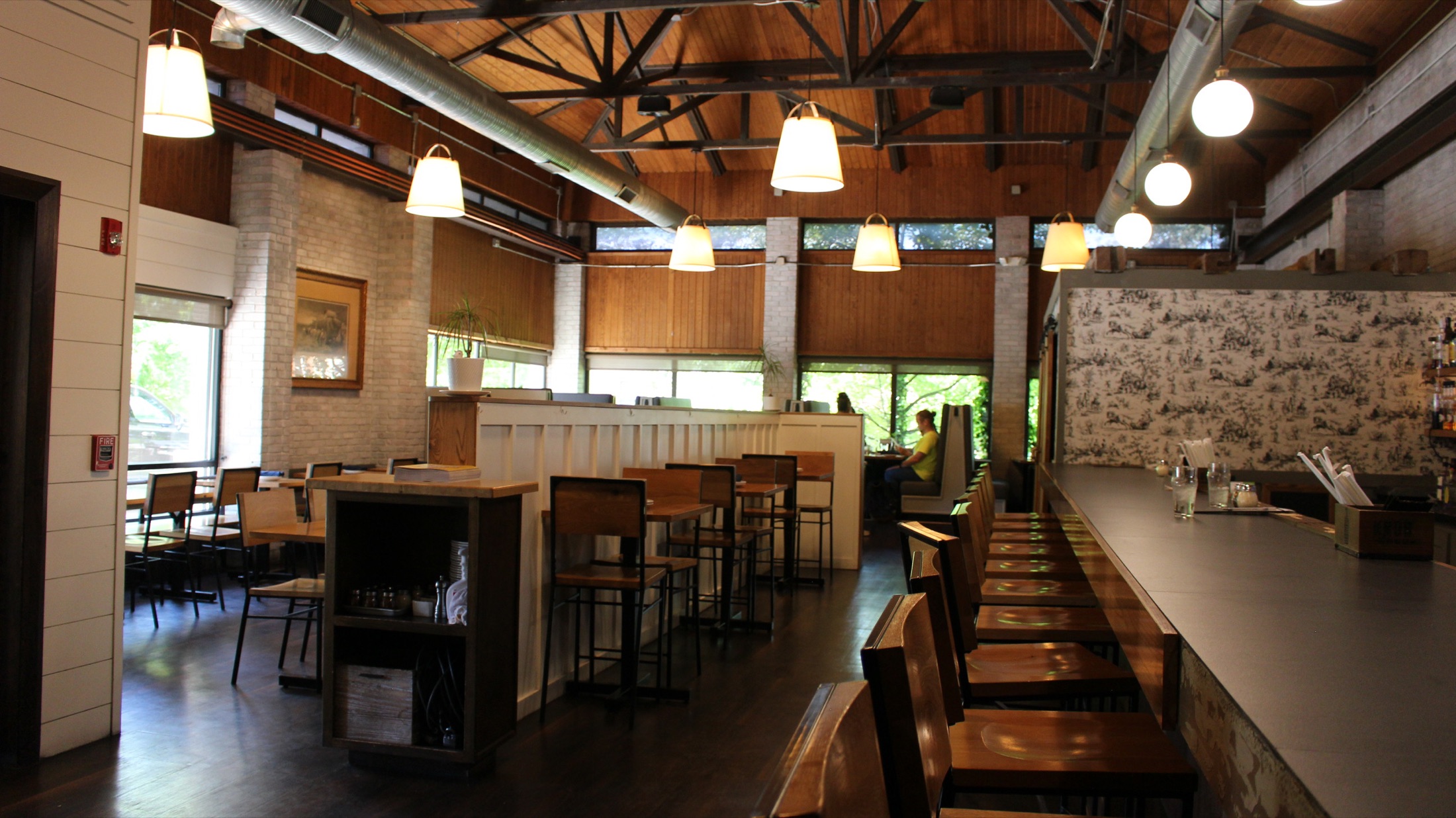 Brewery District dining room with cathedral ceiling and toile wallpaper bar
