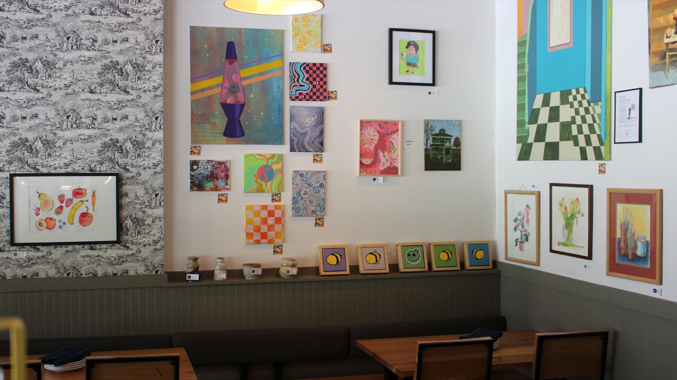 Clintonville banquette under a wall of rotating local art