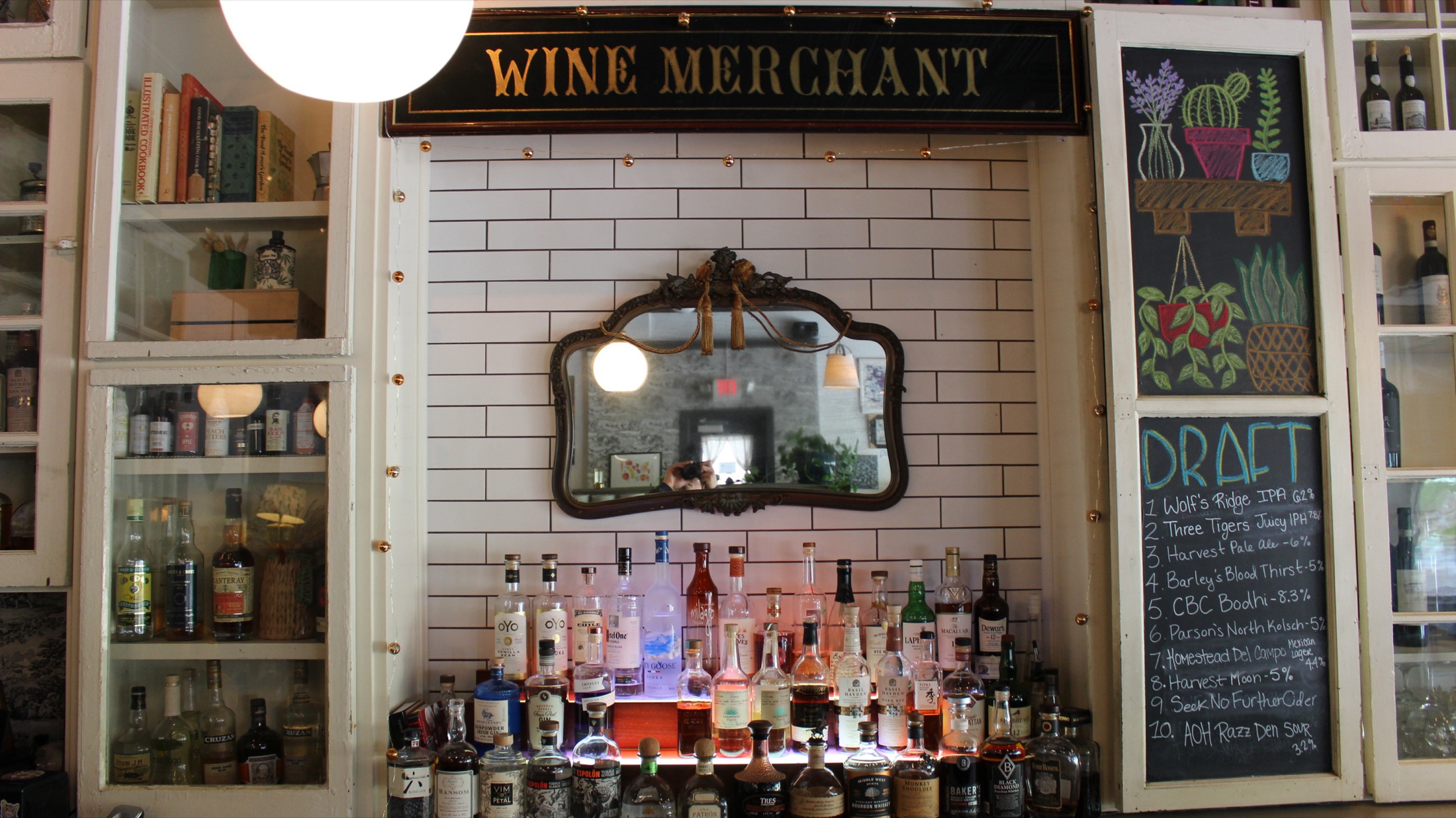 Wine Merchant signage with vintage mirror and backlit spirits