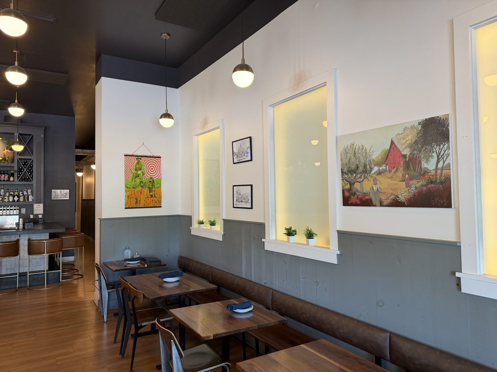 Harvest Granville banquette wall with local artwork including a red barn painting