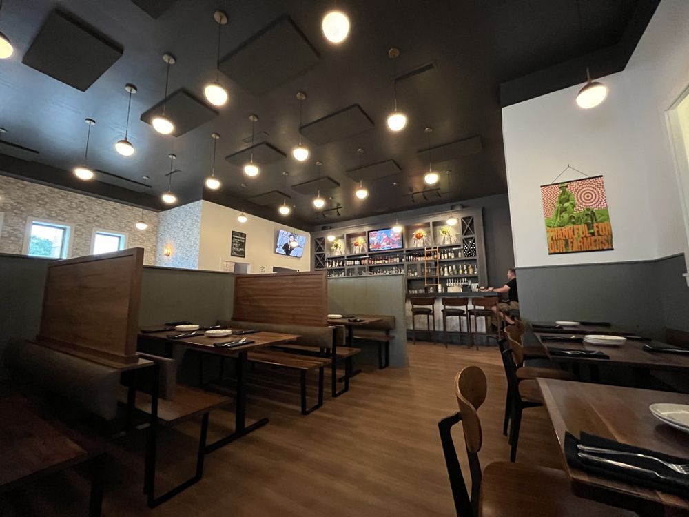 Harvest Granville dining room booths beneath a Thankful for our Farmers print