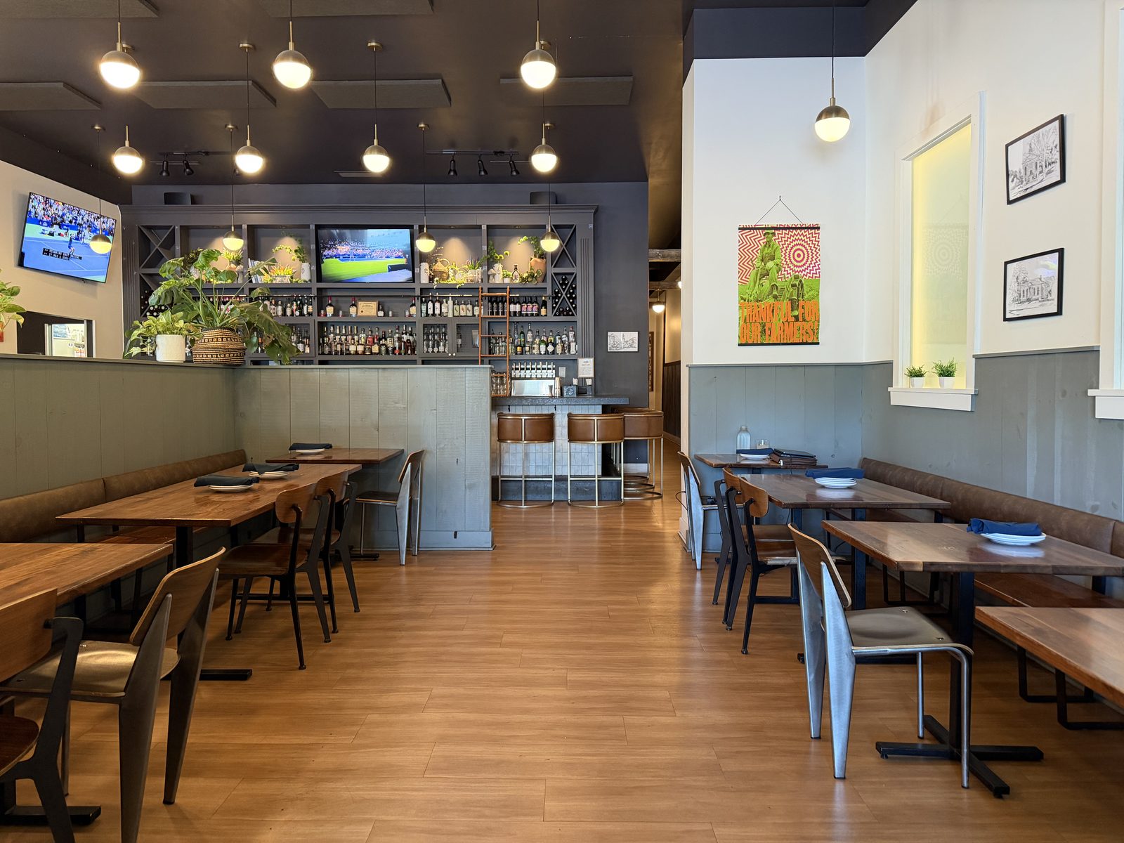 Harvest Granville dining room and bar beneath a Thankful for our Farmers print