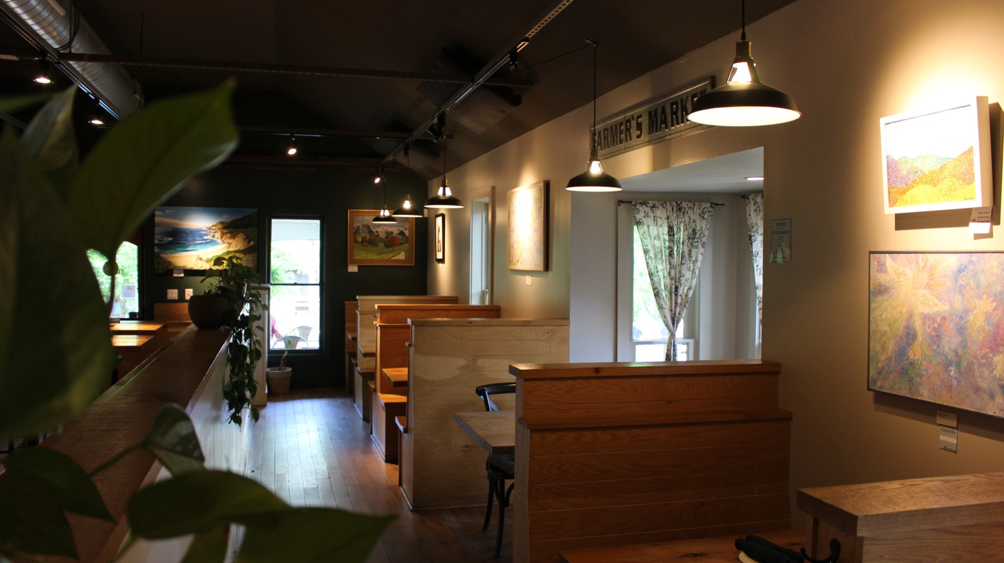 Harvest Dublin dining room booths with rotating local art and Farmer's Market signage
